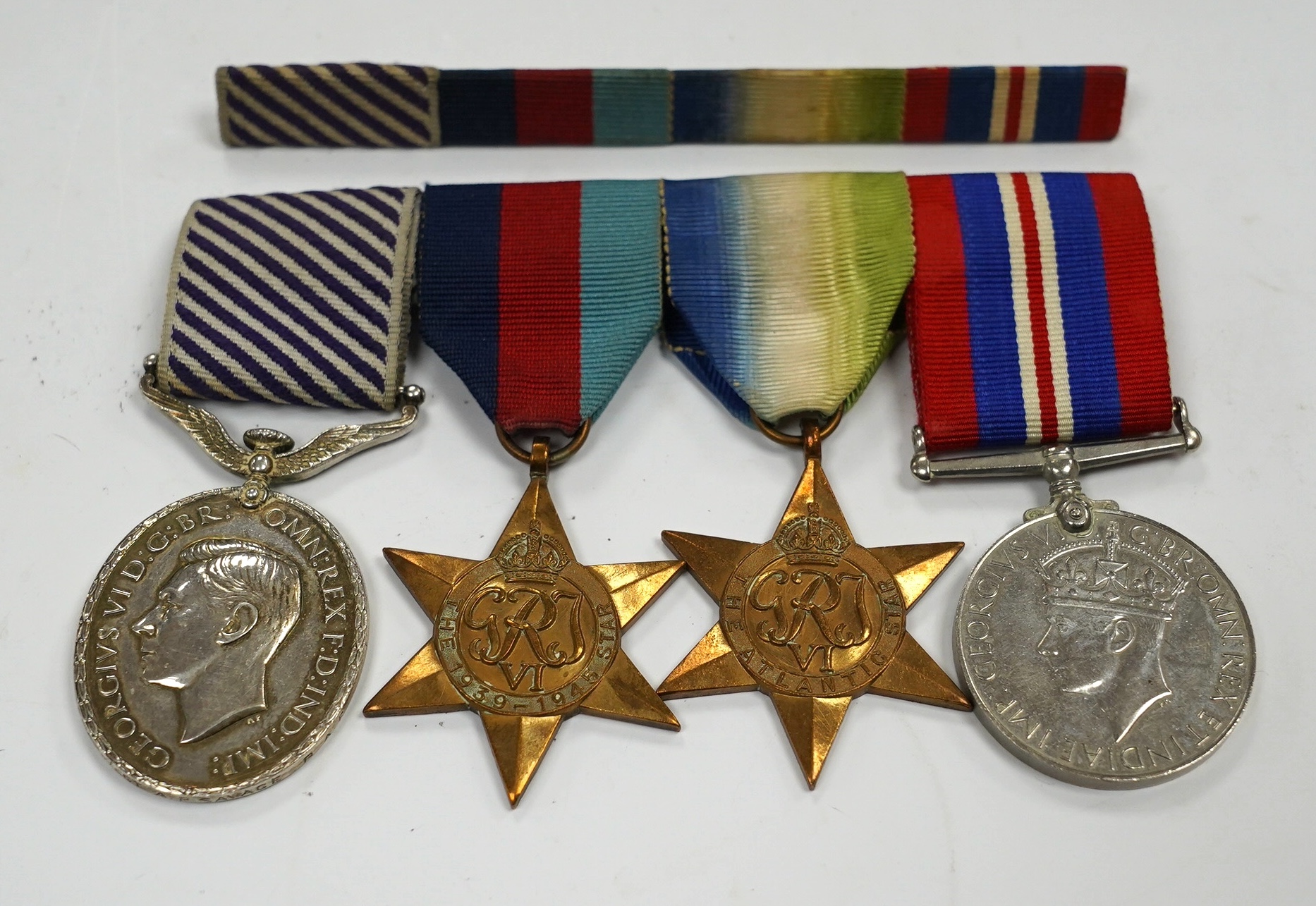 A Distinguished Flying Medal group awarded to Flight Sergeant A. Savage, comprising of the Distinguished Flying Medal together with the Atlantic Star, the 1939-1945 Star and the War Medal